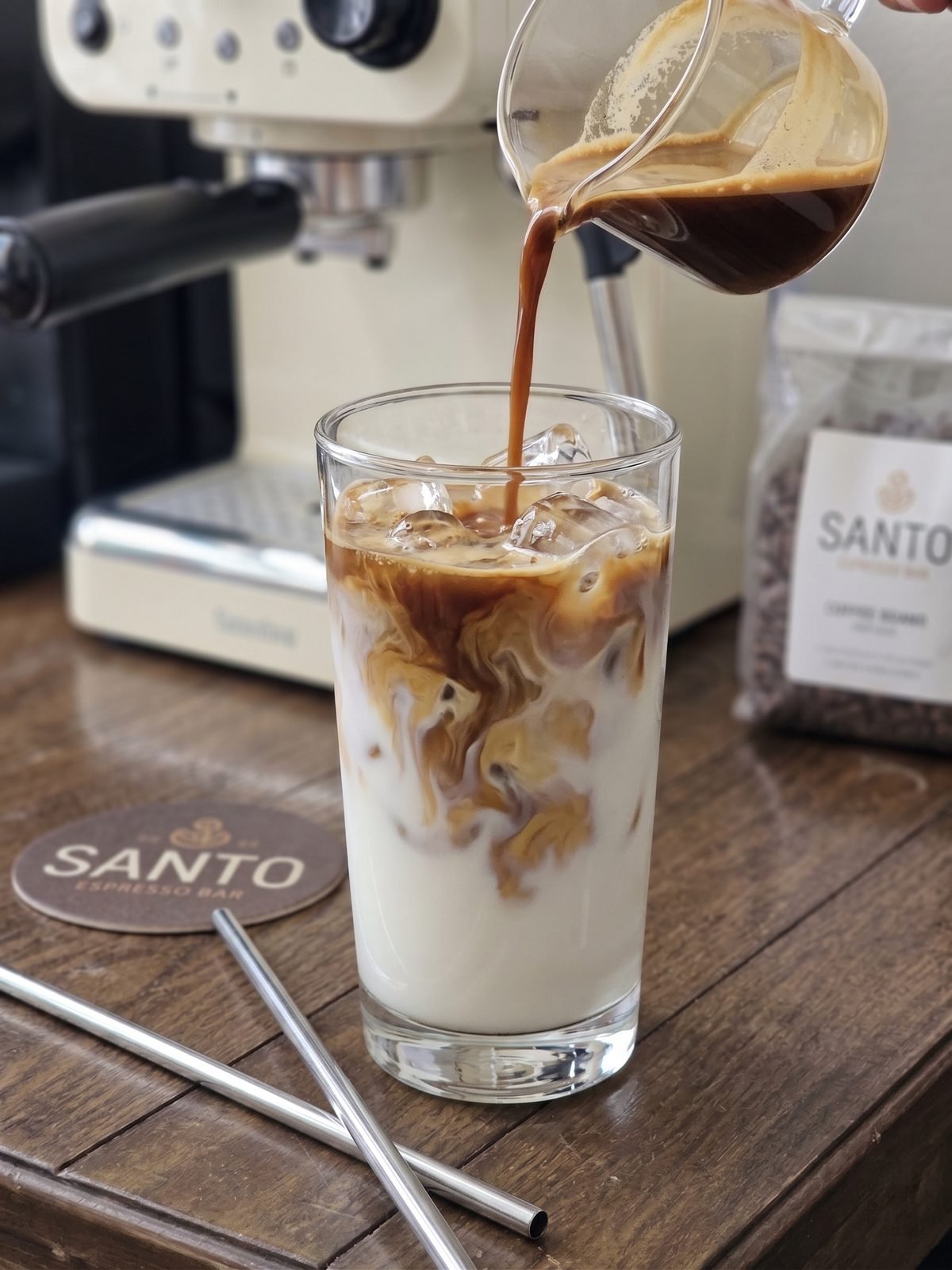 Pouring an iced Santo Cafe latte